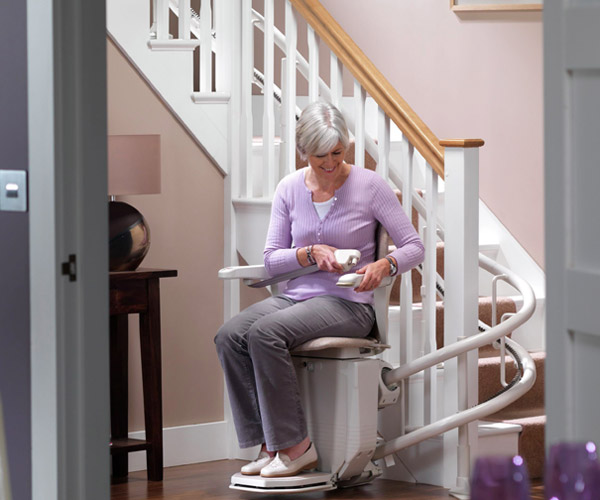 woman on residential stairlift image on Bedco Mobility website