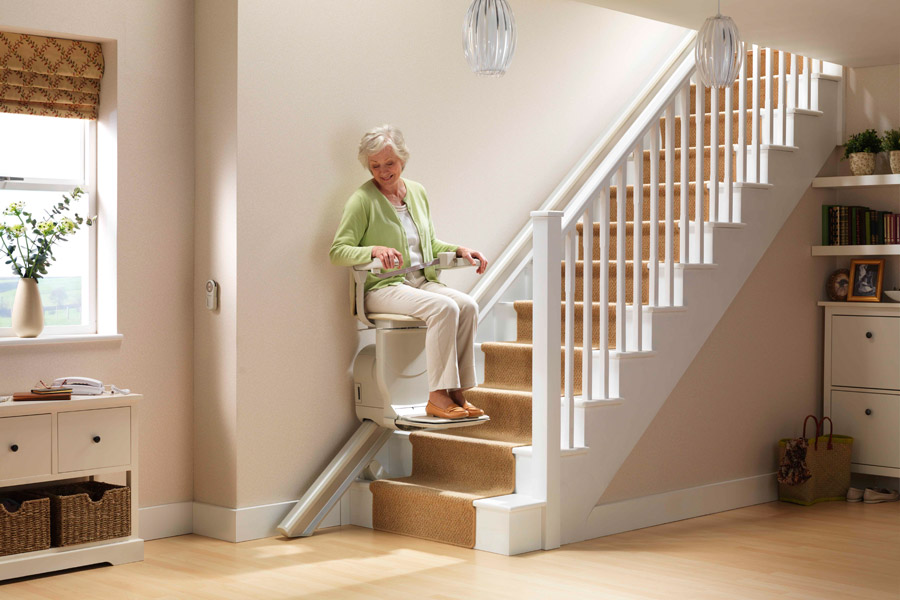 woman on residential stairlift on Bedco Mobility website